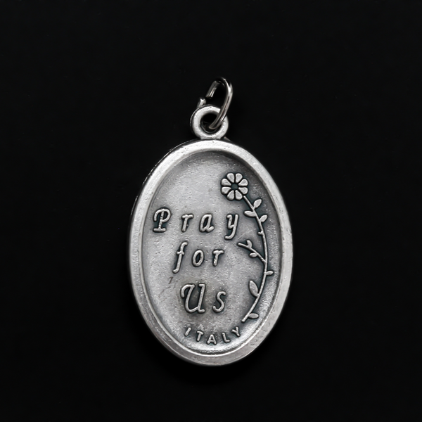 Saint Faustina medal that depicts the saint on the front and is marked "pray For Us" on the backside.