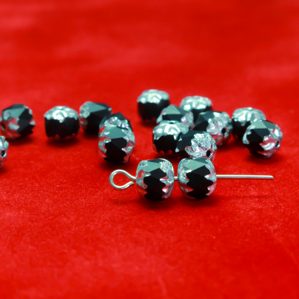 Cathedral shape beads that are faceted. The top and the bottom of the bead are a patterned glass with a silver coating. Made in the Czech Republic. Sold in sets of 20 beads.