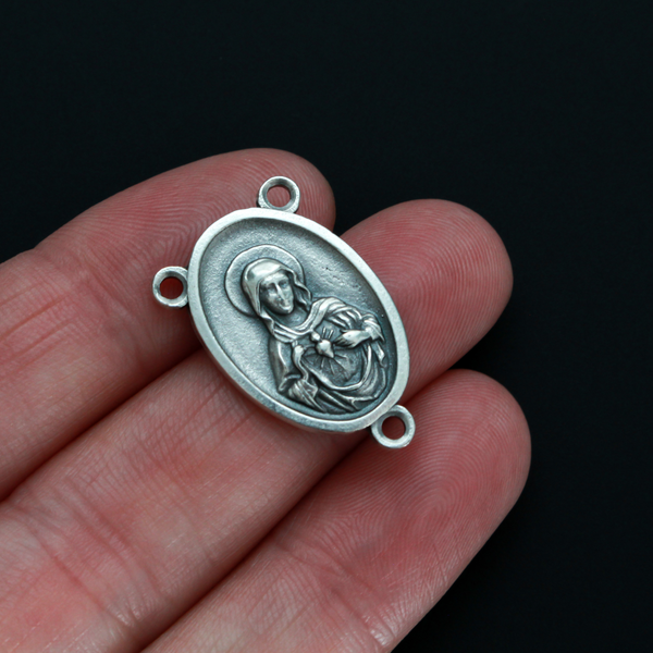 One inch oval rosary centerpiece that features an image of The Immaculate Heart of Mary on the front with an image of The Sacred Heart of Jesus on the back